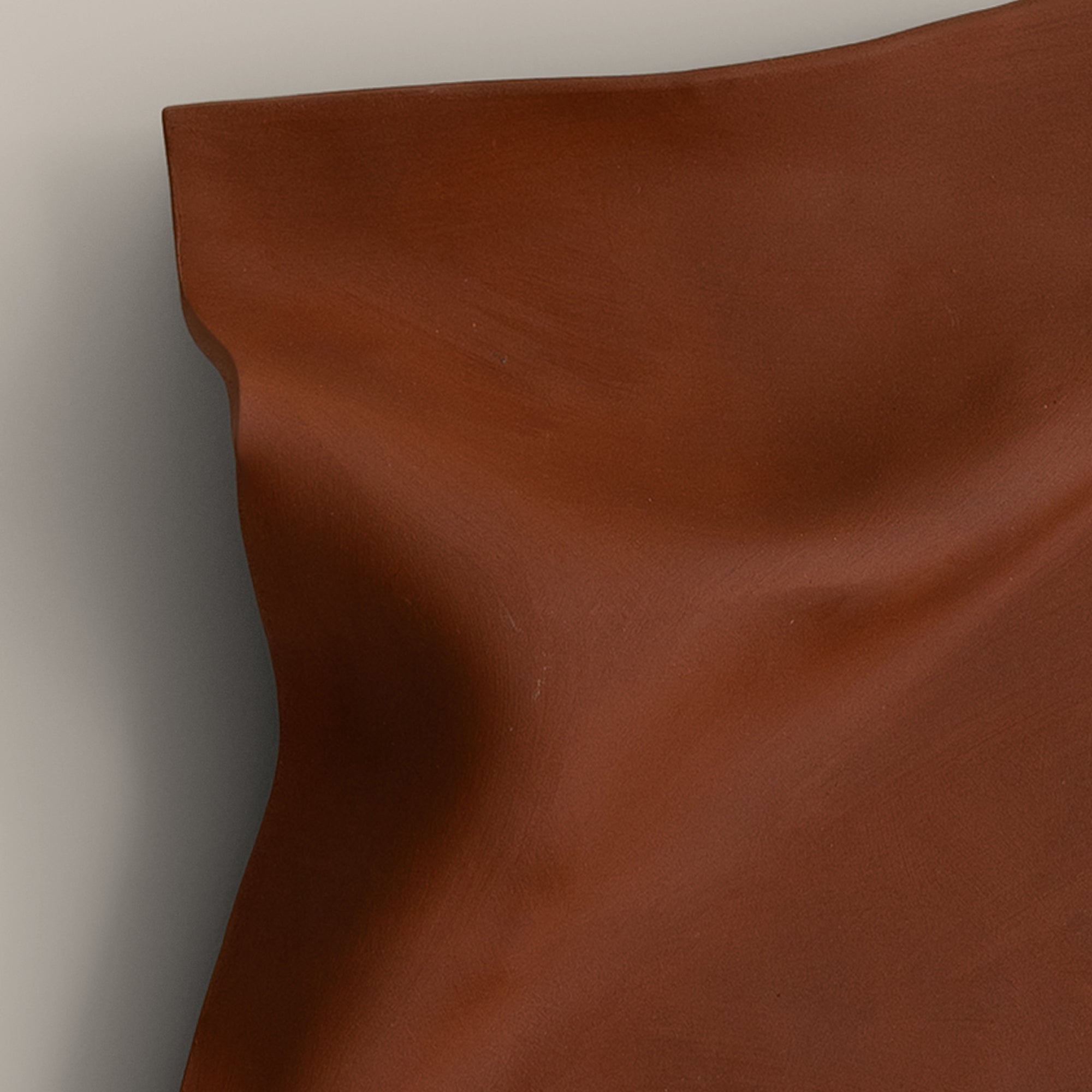 Writings 003 by Studio JOA — close-up of the pinched fold in Stone Red stoneware, showing the hand-brushed surface texture