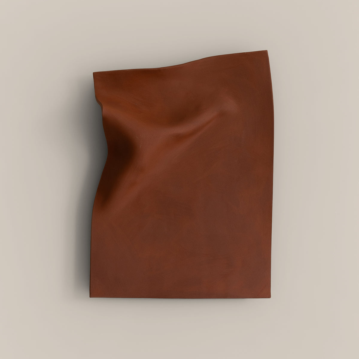 Writings 003 by Studio JOA — Stone Red stoneware wall piece with a pinched vertical fold along one edge, photographed against a plain wall