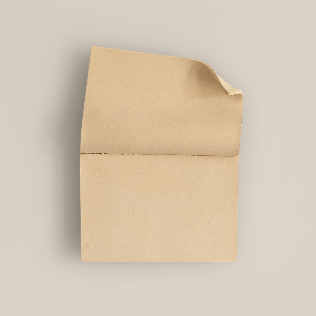 Writings 001 by Studio JOA — Butter Yellow folded stoneware wall piece, photographed against a plain wall