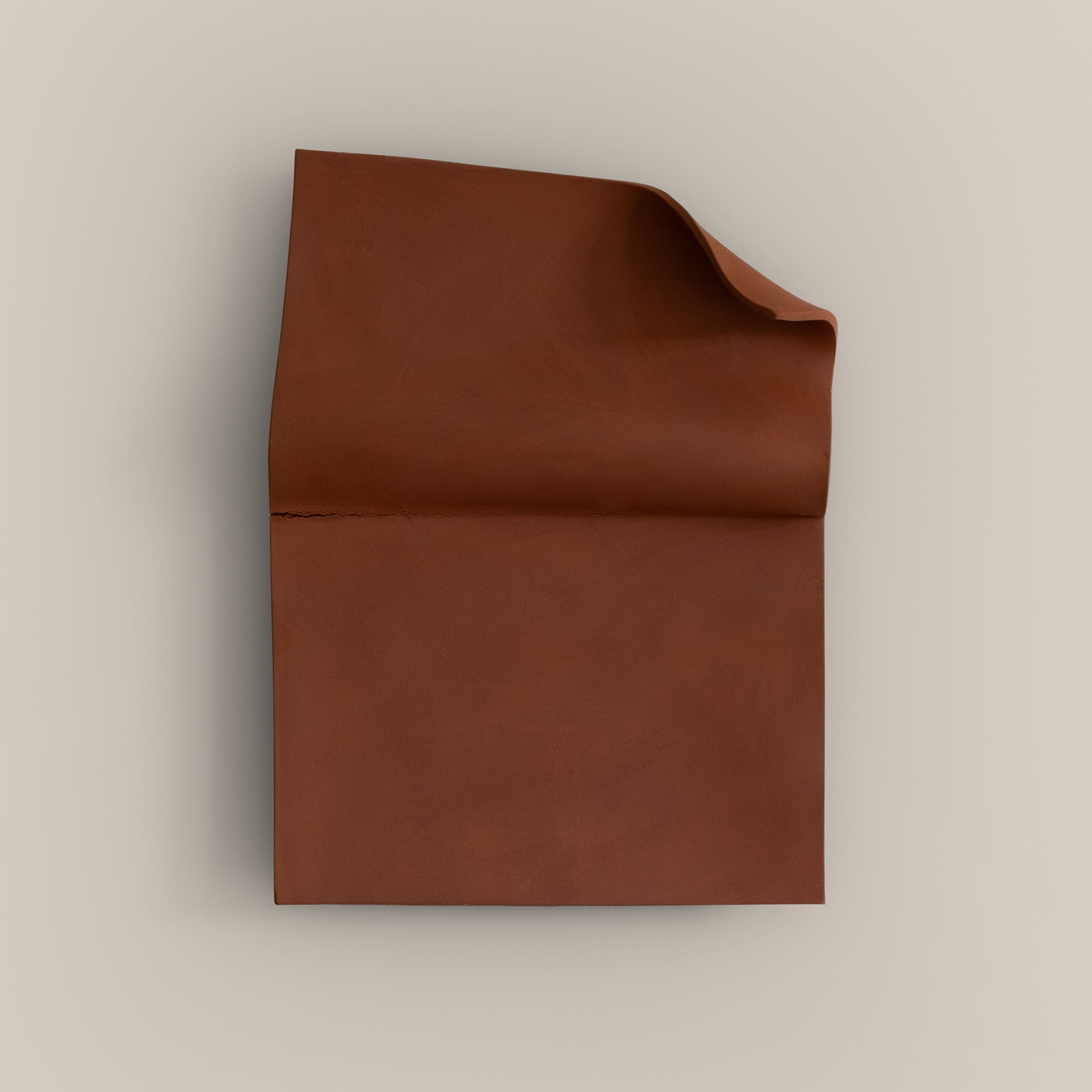 Writings 001 by Studio JOA — Stone Red folded stoneware wall piece, photographed against a plain wall