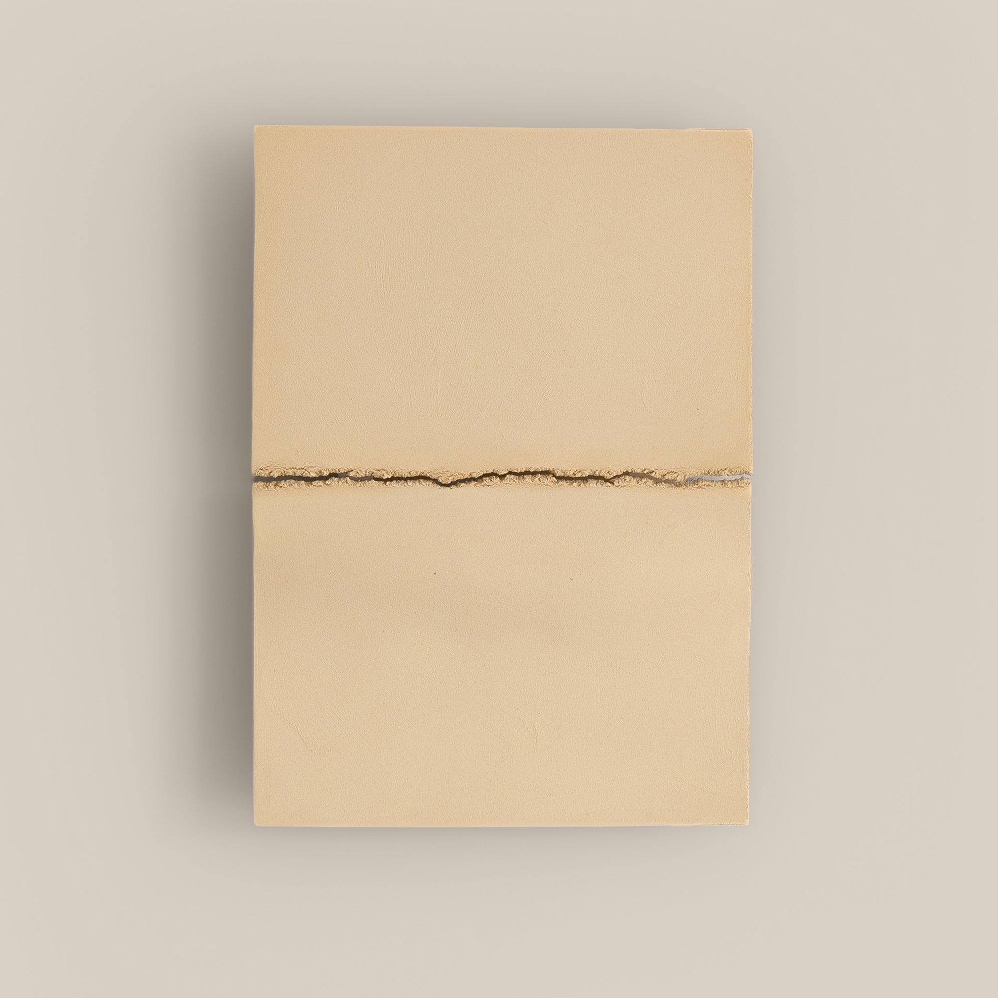 Writings 002 by Studio JOA — Butter Yellow stoneware wall piece with a single horizontal seam, photographed against a plain wall