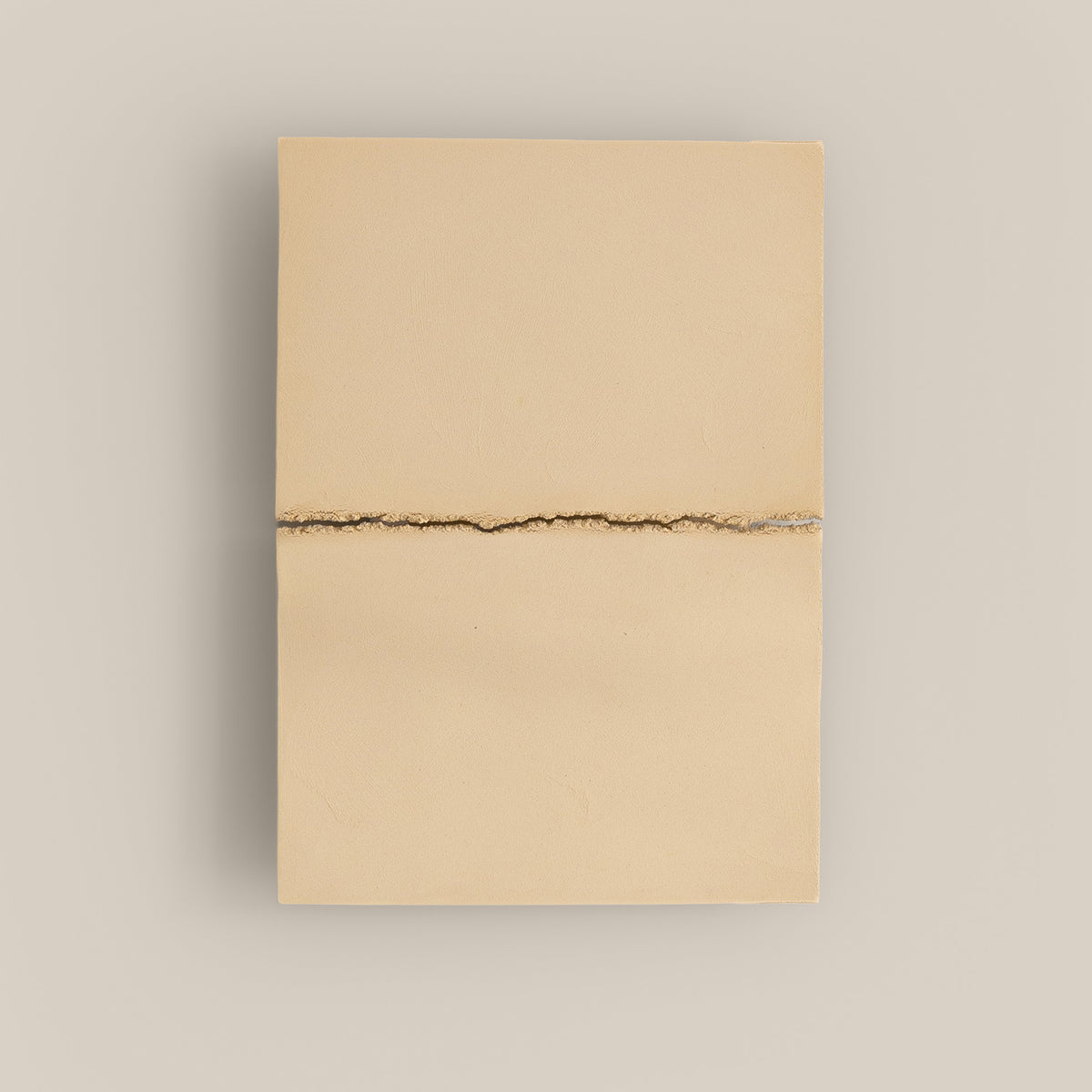 Writings 002 by Studio JOA — Butter Yellow stoneware wall piece with a single horizontal seam, photographed against a plain wall