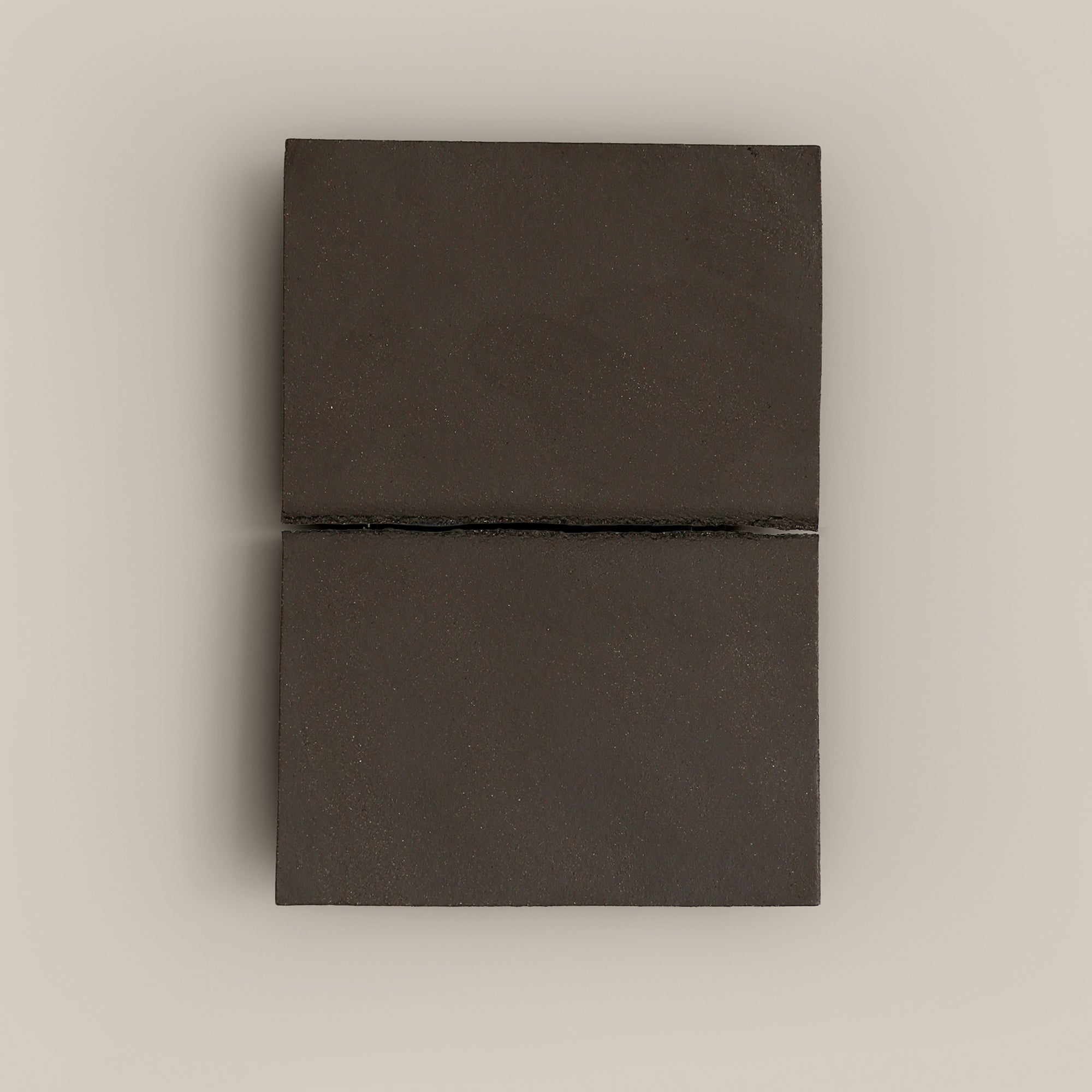 Writings 002 by Studio JOA — Dark Brown stoneware wall piece with a single horizontal seam, photographed against a plain wall