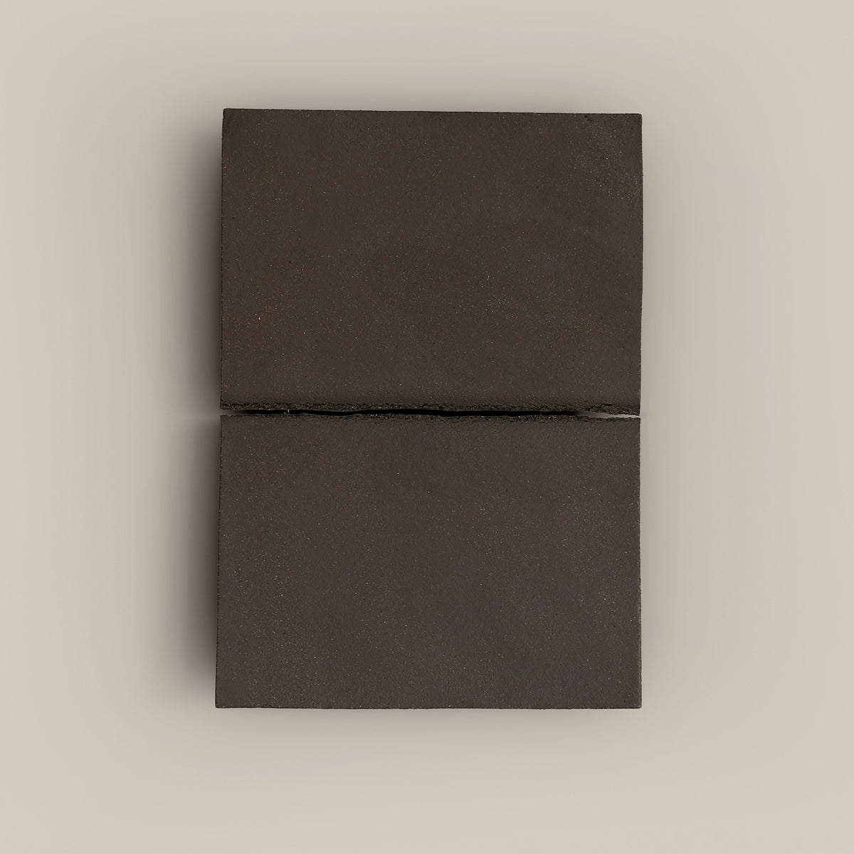 Writings 002 by Studio JOA — Dark Brown stoneware wall piece with a single horizontal seam, photographed against a plain wall