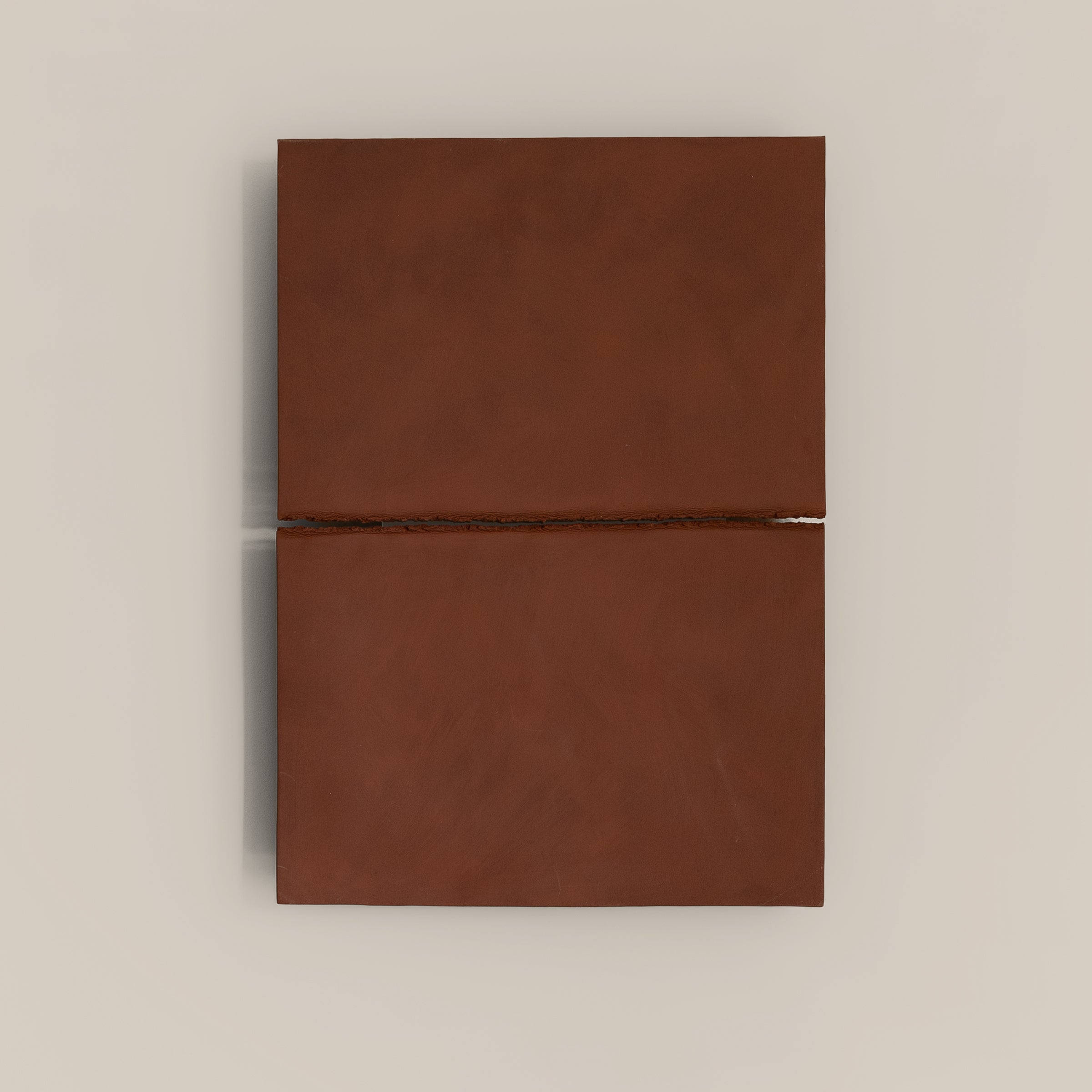 Writings 002 by Studio JOA — Stone Red stoneware wall piece with a single horizontal seam, photographed against a plain wall