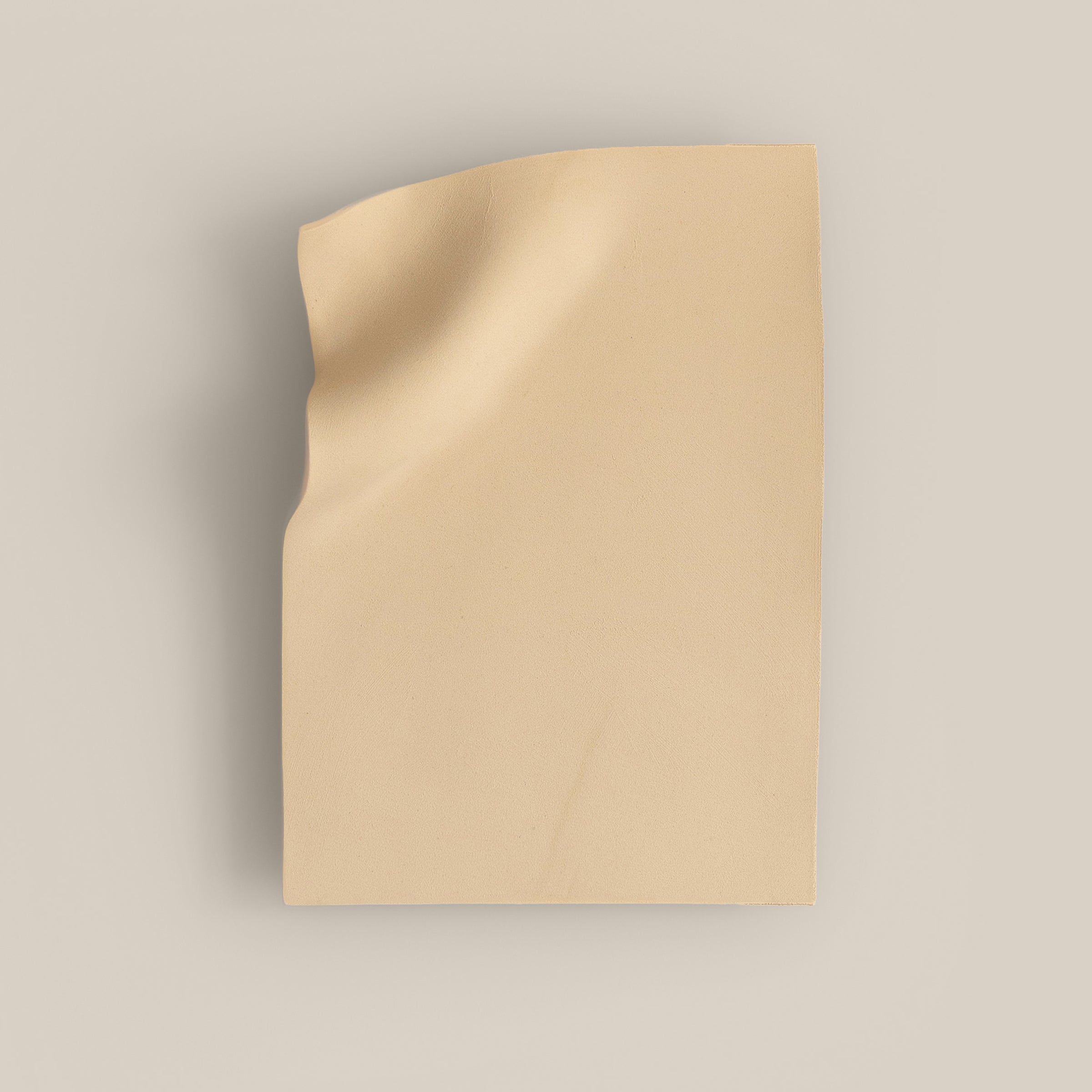 Writings 003 by Studio JOA — Butter Yellow stoneware wall piece with a pinched vertical fold along one edge, photographed against a plain wall