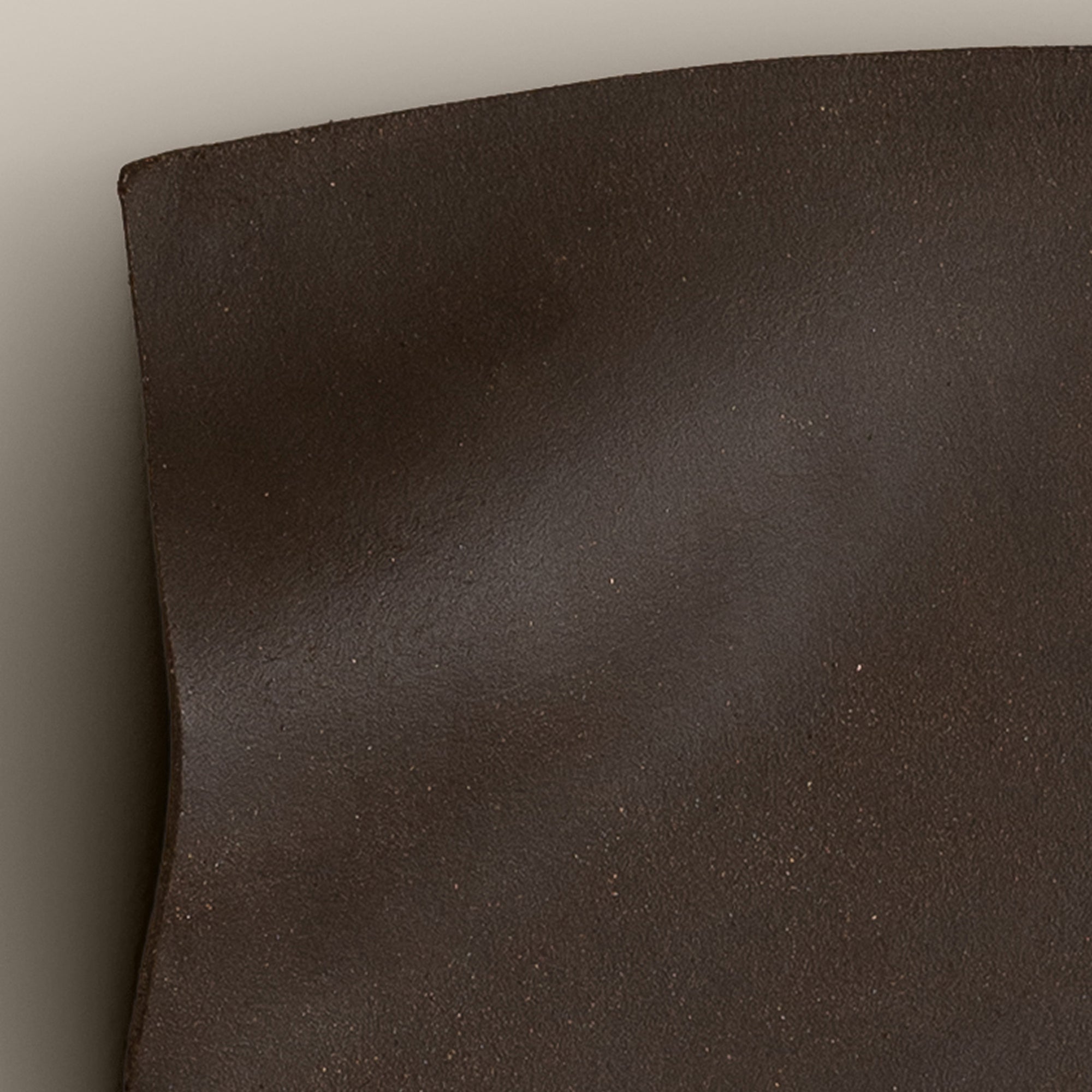 Writings 003 by Studio JOA — close-up of the pinched fold in Dark Brown stoneware, showing the hand-brushed surface texture